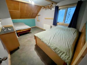 bedroom with a double bed, single bed and sink